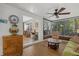 Sunroom featuring lots of natural light, a ceiling fan, wood-look floors, and views to multiple other rooms at 7207 Oak Moss Dr # 63, Sarasota, FL 34241