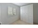 White bedroom with built-in storage and window shutters at 852 Golden Beach Blvd # 852, Venice, FL 34285