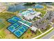 Aerial view of a community clubhouse, with tennis and pickleball courts and an expansive pool and amenity area at 9244 Ballaster Pointe Loop, Parrish, FL 34219