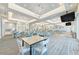 Spacious amenity room with modern decor, elegant chandeliers, and ample seating for various community activities at 9244 Ballaster Pointe Loop, Parrish, FL 34219