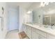 Modern bathroom with double sink vanity, quartz countertops and a glass-enclosed shower at 9244 Ballaster Pointe Loop, Parrish, FL 34219