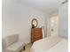 Charming bedroom with dresser, chair, and view into another room at 9244 Ballaster Pointe Loop, Parrish, FL 34219