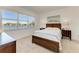 Bedroom with large windows offering lake views at 9244 Ballaster Pointe Loop, Parrish, FL 34219