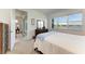 Bedroom with large windows offering lake views at 9244 Ballaster Pointe Loop, Parrish, FL 34219