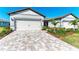 House exterior showcasing a two-car garage and well-maintained landscaping at 9244 Ballaster Pointe Loop, Parrish, FL 34219
