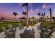 Inviting fire pit area with Adirondack chairs for cozy evenings in a tropical community setting at 9244 Ballaster Pointe Loop, Parrish, FL 34219