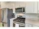 Close up of the kitchen with stainless steel appliances and white cabinets at 9244 Ballaster Pointe Loop, Parrish, FL 34219