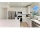Bright kitchen featuring white cabinets, stainless steel appliances, and quartz countertops at 9244 Ballaster Pointe Loop, Parrish, FL 34219