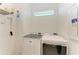 Laundry room featuring Maytag washer and dryer with wire shelving and storage at 9244 Ballaster Pointe Loop, Parrish, FL 34219