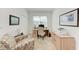 Well-lit home office featuring a desk, chair, closet, filing cabinet and comfortable seating at 9244 Ballaster Pointe Loop, Parrish, FL 34219