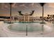The community pool features lounge chairs, palm trees, fountains, and a beautiful sunset at 9244 Ballaster Pointe Loop, Parrish, FL 34219