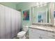 Bathroom features a shower with curtain, granite vanity top, and updated fixtures at 10379 Medjool Dr, Venice, FL 34293