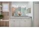 Bright bathroom with dual vanities, a large mirror, and a walk-in shower at 10379 Medjool Dr, Venice, FL 34293