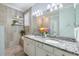Elegant bathroom with dual sinks, granite countertops, and a large mirror at 10379 Medjool Dr, Venice, FL 34293