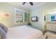 Bright bedroom with a queen bed, ceiling fan, and en suite bathroom at 10379 Medjool Dr, Venice, FL 34293