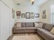 Cozy bonus room featuring a sectional sofa and decorative wall art at 10379 Medjool Dr, Venice, FL 34293