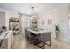 Dining room featuring a modern light fixture, seating for six, and stylish decor at 10379 Medjool Dr, Venice, FL 34293