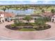 Scenic entrance to Sarasota National featuring lush landscaping and a glimpse of the golf course and lake at 10379 Medjool Dr, Venice, FL 34293