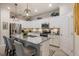 Well-equipped kitchen featuring granite counters, stainless steel appliances, and a breakfast bar with pendant lighting at 10379 Medjool Dr, Venice, FL 34293