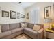 Comfortable living room features a gray sectional sofa and decorative pillows at 10379 Medjool Dr, Venice, FL 34293