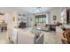Cozy living room with comfortable sofas, stylish decor, and a large window offering natural light at 10379 Medjool Dr, Venice, FL 34293