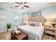 Light-filled main bedroom featuring light blue walls and an ensuite bathroom at 10379 Medjool Dr, Venice, FL 34293