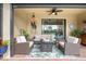 Outdoor patio area with comfortable seating, ceiling fan, and view of the pool at 10379 Medjool Dr, Venice, FL 34293