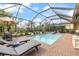 Inviting screened pool area with chaise lounges and lush landscaping for a serene outdoor experience at 10379 Medjool Dr, Venice, FL 34293