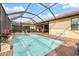 A refreshing screened pool with a connecting hot tub and ample patio space for outdoor entertaining at 10379 Medjool Dr, Venice, FL 34293
