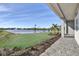 Serene backyard view overlooking a peaceful lake and fountain, providing a relaxing outdoor space at 17920 Palmiste Dr, Bradenton, FL 34202