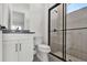 Modern bathroom featuring a glass-enclosed shower, and a sleek vanity with black hardware at 17920 Palmiste Dr, Bradenton, FL 34202