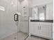 Modern bathroom with a glass-enclosed shower, white cabinets, and sleek fixtures at 17920 Palmiste Dr, Bradenton, FL 34202