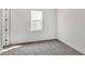 This bedroom features neutral carpet, a window, white walls, and white trim at 17920 Palmiste Dr, Bradenton, FL 34202