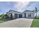 Beautiful home with a three-car garage and a paver driveway, offering ample parking and curb appeal at 17920 Palmiste Dr, Bradenton, FL 34202