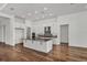 Open concept kitchen with wood floors, large island, white cabinets, stainless steel appliances, and modern design at 17920 Palmiste Dr, Bradenton, FL 34202
