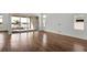 Bright living room featuring sleek hardwood floors and sliding glass doors that offer a lake view at 17920 Palmiste Dr, Bradenton, FL 34202