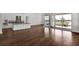 Open-concept living room featuring hardwood floors, a kitchen island, and sliding doors to the patio at 17920 Palmiste Dr, Bradenton, FL 34202
