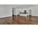 Spacious living room with hardwood floors, white kitchen cabinets, and ample natural light at 17920 Palmiste Dr, Bradenton, FL 34202