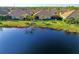 Houses with screened lanais by a lake, offering serene outdoor living spaces at 21620 Avon Park Ct, Venice, FL 34293
