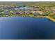 Aerial view of a community, homes, and a lake at 21620 Avon Park Ct, Venice, FL 34293