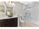 Elegant bathroom with a modern vanity, decorative sink, and glass-enclosed shower-tub combination at 21620 Avon Park Ct, Venice, FL 34293