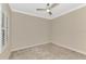 Bright bedroom with plush carpeting, neutral walls, a ceiling fan, and plantation shutters at 21620 Avon Park Ct, Venice, FL 34293