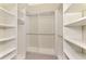 Walk-in closet with built-in shelving, hanging rods, and carpeted floor at 21620 Avon Park Ct, Venice, FL 34293