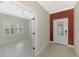 Bright foyer featuring a decorative glass front door and opening into a room with plantation shutters at 21620 Avon Park Ct, Venice, FL 34293