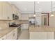 Bright kitchen with stainless steel appliances, granite countertops and white cabinets at 21620 Avon Park Ct, Venice, FL 34293