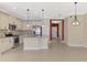 Open kitchen featuring stainless appliances, pendant lighting, and cream colored cabinets at 21620 Avon Park Ct, Venice, FL 34293
