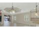 Open-concept floorplan with water view, tile floors, recessed lighting and tray ceiling at 21620 Avon Park Ct, Venice, FL 34293