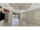 Open-concept floorplan with water view, tray ceiling, and neutral color palette at 21620 Avon Park Ct, Venice, FL 34293