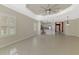 Open concept home with neutral walls, tile floors, and plantation shutters on windows at 21620 Avon Park Ct, Venice, FL 34293