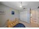 Simple bedroom with a closet, tile flooring, and overhead lighting at 2551 W Burr Oak Ct, Sarasota, FL 34232